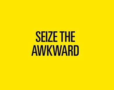 Yellow background with black text inside a speech bubble outline that reads, SEIZE THE AWKWARD. The word AWKWARD is separated and offset within the bubble.